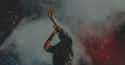 Placeholder Image An artist on stage singing into a microphone